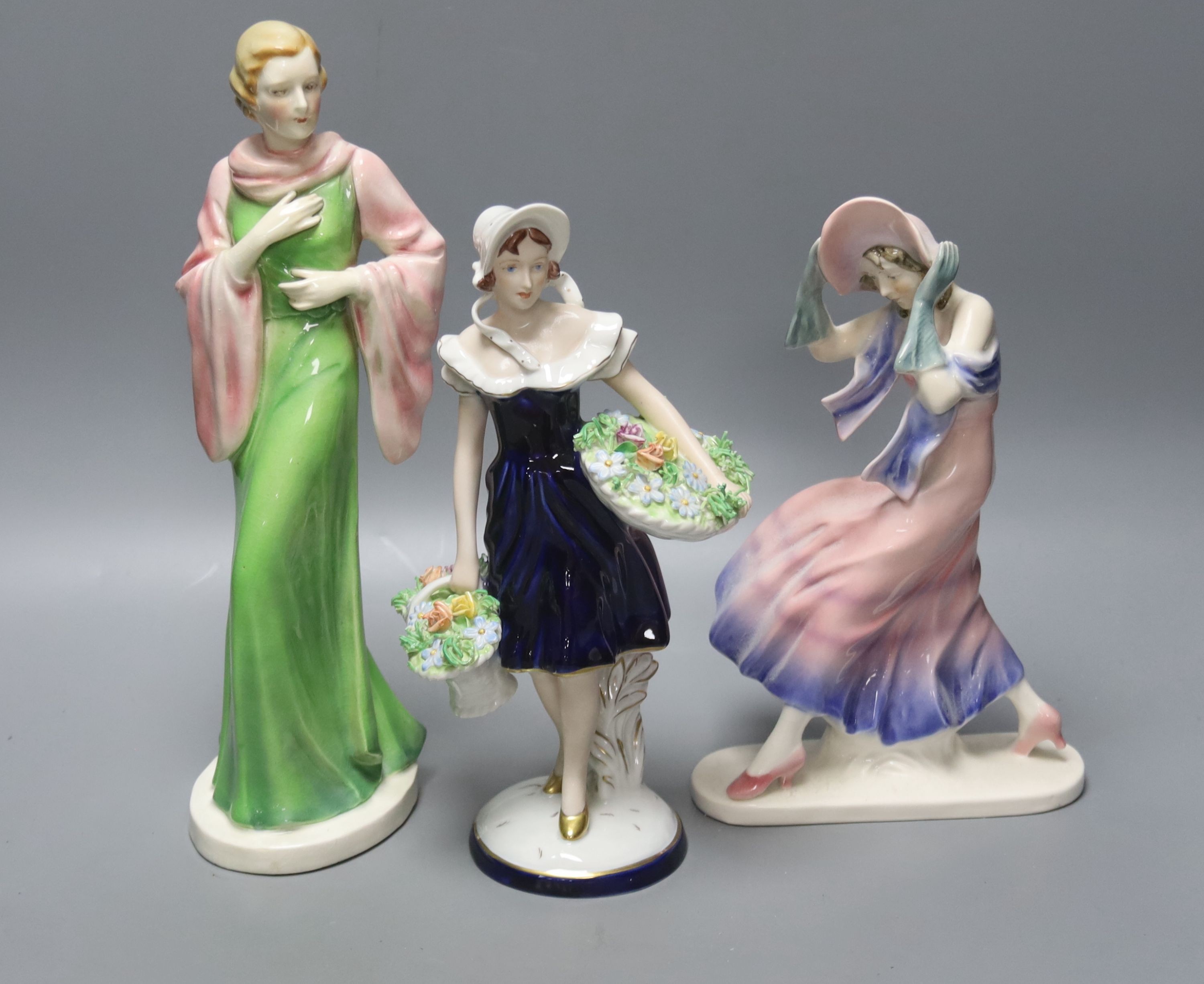 A Royal Dux figurine of a flower girl, height 26cm and two other figurines